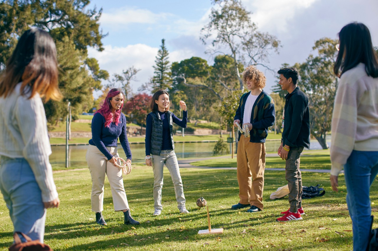 International students socialising by River Torrens