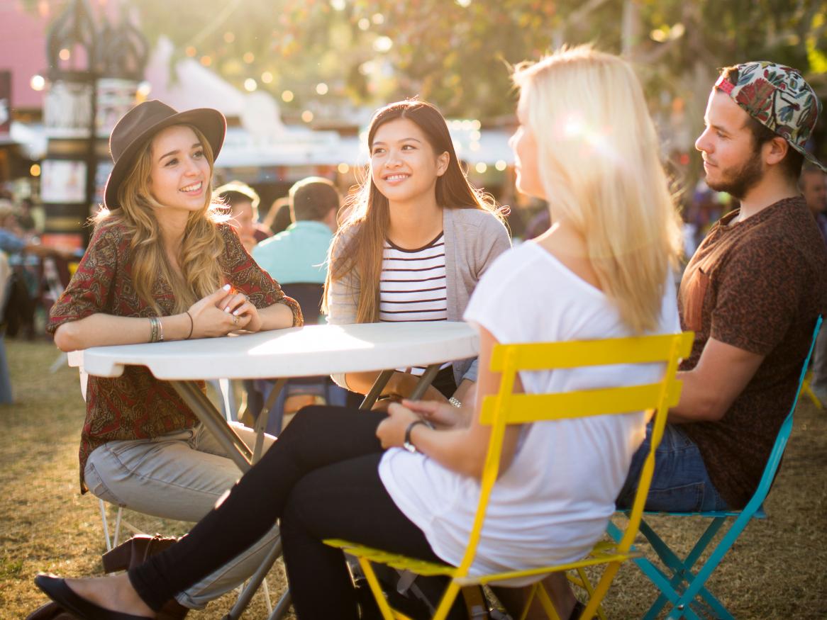 Students socialising around a table at an event